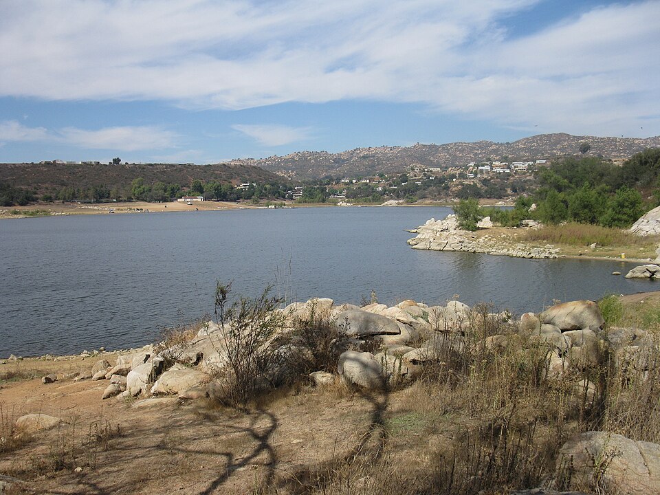 View across Lake Wohlford with hills and shoreline vegetation.